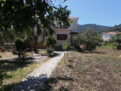 a house with a garden in front of it at Vassilis Studios in Anaxos