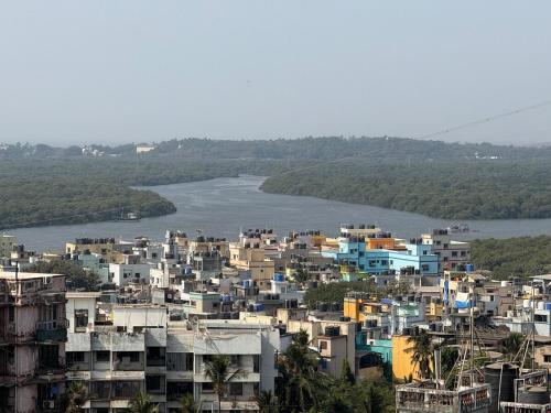 a city with buildings and a body of water at Creek View Studio Apartment in Mumbai