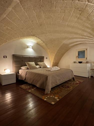 a bedroom with a large bed in an attic at Il Maniero casa vacanze by MOH in Grottaglie