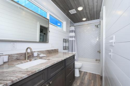 a bathroom with a sink and a toilet at TV Blue Tiny Houseboat at Lake Cumberland Marina in Nancy