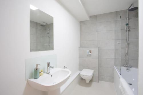 a white bathroom with a sink and a toilet at 2BR, smart TV, self check-in, coffee machine in Manchester