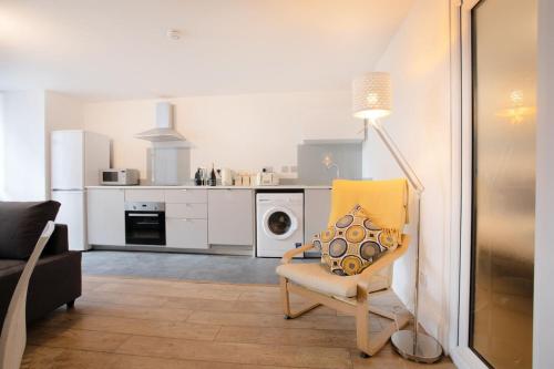 a white living room with a chair and a lamp at 2BR, smart TV, self check-in, coffee machine in Manchester