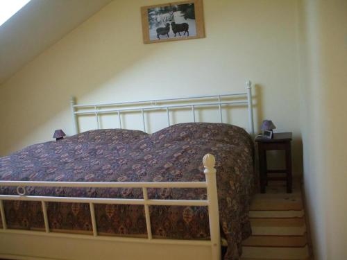 a bedroom with a bed in a room with a staircase at Ferienhaus In Kienitz Mit Grill, Terrasse Und Garten in Letschin