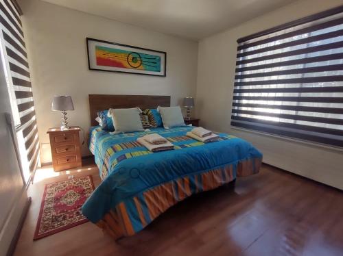 a bedroom with a bed and a large window at Garcia hurtado departamento diario in Osorno