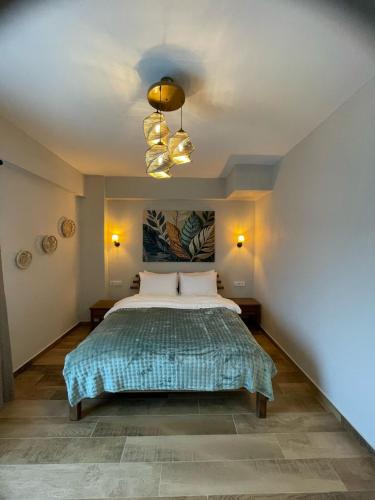 a bedroom with a bed and a chandelier at Kyla Kocadere Mansion in Eceabat