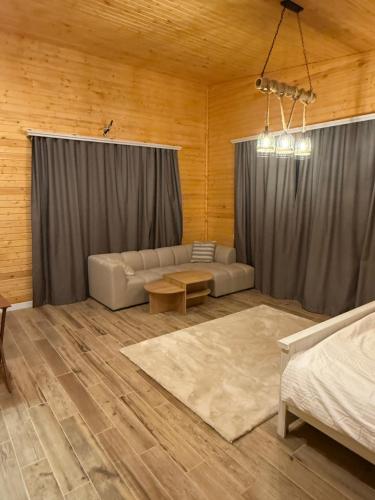 a living room with a couch and a table at Denver Villa in Sagmosavan