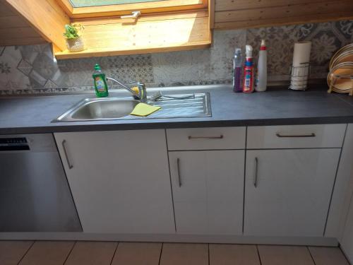 a kitchen with a sink and a counter top at Ferienwohnung Kirchbergblick In Durbach in Durbach