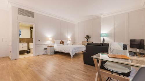 a large living room with a bed and a couch at Bank Serviced Apartments by LovelyStay in London