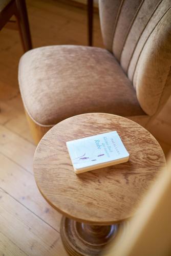 a table with a book sitting on top of a chair at Ferienhaus am Spiegelberg in Lemgo in Lemgo