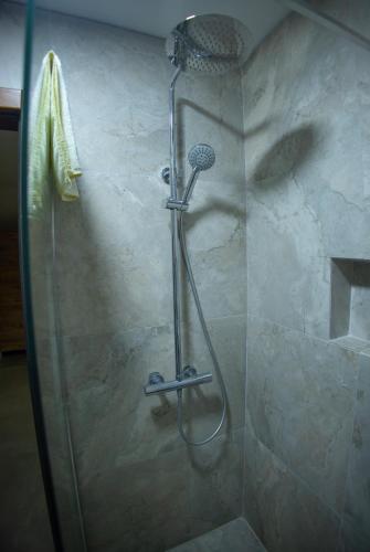 a shower with a shower head in a bathroom at Villa Noari, Brezovice. in Brezovicë