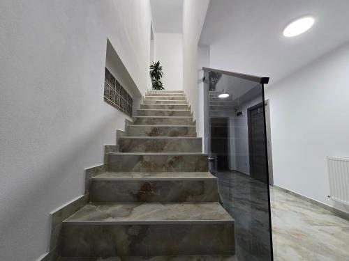 a staircase in a house with concrete steps at Boutique Arena in Piteşti