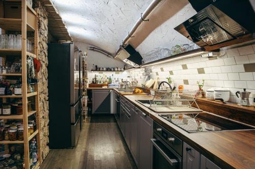 a kitchen with a sink and a refrigerator at TÉGED VÁRTALaK in Dörgicse