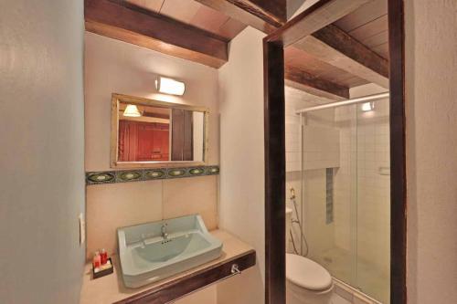 a bathroom with a sink and a toilet and a shower at Pousada do Amparo in Olinda