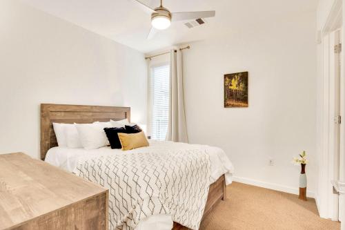 a white bedroom with a bed and a window at My Sweet Rentals- 30 night min in Aurora