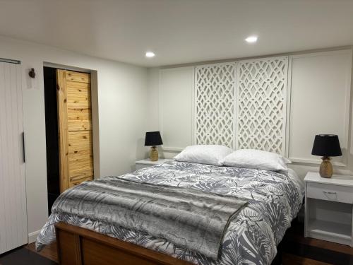 a bedroom with a large bed and two night stands at le sous sol du vétérans in Lac-Mégantic
