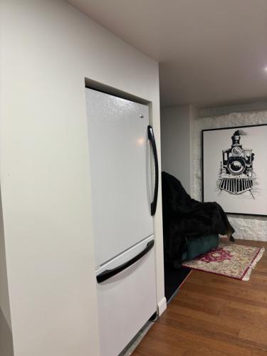 a kitchen with a refrigerator in a room at le sous sol du vétérans in Lac-Mégantic