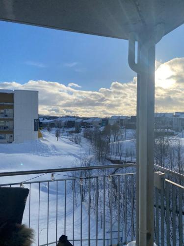 a view of a snow covered field from a balcony at Moderne leilighet, 3 sov, parkering. in Trondheim