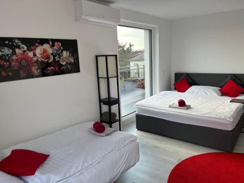 a bedroom with two beds and a window at Weißes Haus in Gerasdorf bei Wien