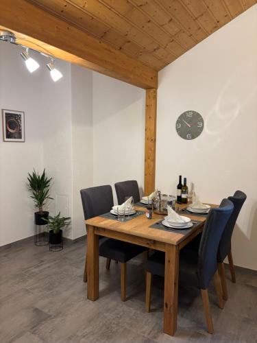 a dining room with a wooden table and chairs at Ferienwohnung Reifferscheid - Eifel in Hellenthal