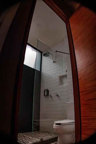 a bathroom with a toilet and a glass shower at Elena de Cobre, Leon, a Member of Design Hotels in León