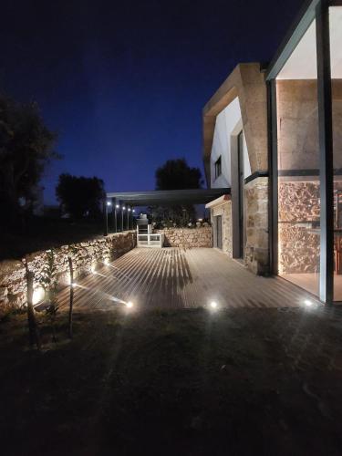a building with lights on the side of it at night at Quinta da Sra Marocas in Covilhã