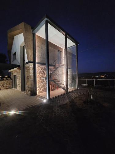 a large glass window on a building at night at Quinta da Sra Marocas in Covilhã