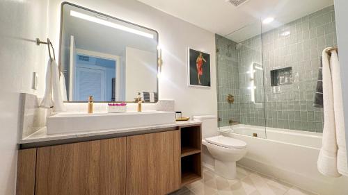 a bathroom with a sink and a toilet and a shower at Private Beach Club Access & Stunning Ocean Views in Miami