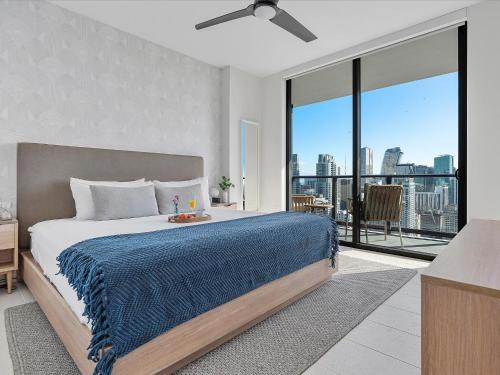 a bedroom with a large bed with a blue blanket at Private Beach Club Access & Stunning Ocean Views in Miami
