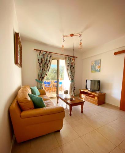 a living room with a couch and a tv at STAY Meadow Vista Apartment in Mandria