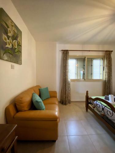 a living room with a couch and a window at STAY Meadow Vista Apartment in Mandria