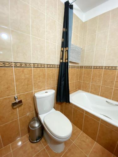 a bathroom with a toilet and a bath tub at STAY Meadow Vista Apartment in Mandria