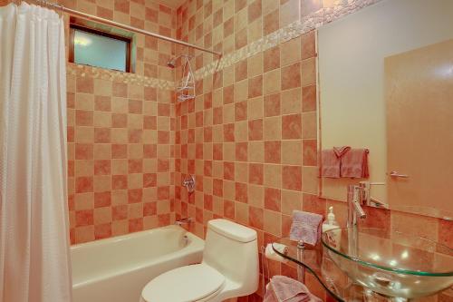 a bathroom with a toilet and a tub and a sink at Alizes 30 Day in Hood River