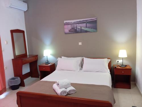 a bedroom with a bed with two towels on it at ARTEMIS beach studios in Kalamaki Heraklion