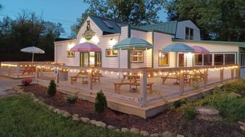 a restaurant with a deck with tables and umbrellas at Wintergreen Ridge Retreat - Family Home in Wintergreen