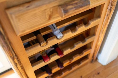 a wooden wine cellar with bottles of wine at Wintergreen Ridge Retreat - Family Home in Wintergreen