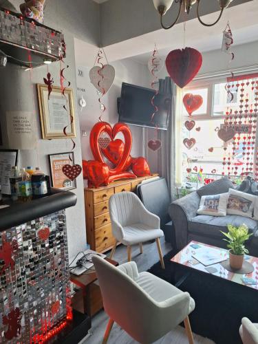 a living room with hearts hanging on the wall at The Garnett in Blackpool