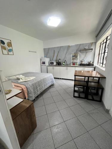 a kitchen with a bed and a table in a room at Albano apartamento 2 en casa vacacional in Mariscal Castilla
