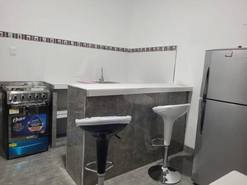 a kitchen with a sink and a refrigerator at Departamento en Máncora, Piura, Perú in Máncora