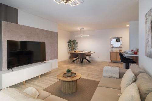 a living room with a large flat screen tv at Uptown II by An Island Apart in Funchal