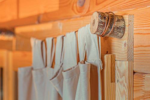 a bunch of white curtains hanging on a wall at Domaine de la Vitarelle Glamping in Villanière