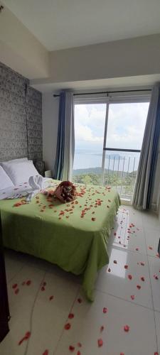 a bedroom with a bed with flowers on the floor at Rm Staycation TaalView Smdc in Tagaytay