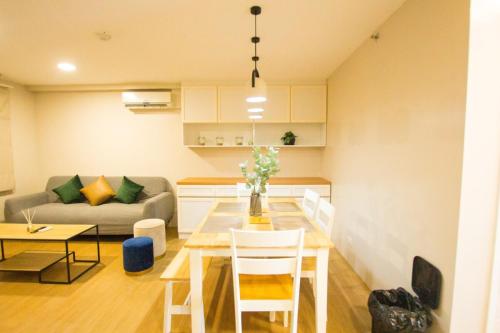 a living room with a table and a couch at Casa - Coastal Getaway Two-Bedroom Vacation Home with free parking in Amalfi by City de Mare in Cebu City