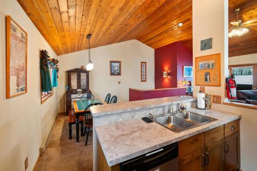 a kitchen with a sink and a counter top at Cozy Ski-In Ski-Out Big Mountain Condo in Whitefish