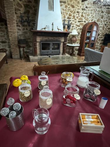 a table with jars of food on a purple table cloth at La Casona De Jaraiz in Jaraiz de la Vera