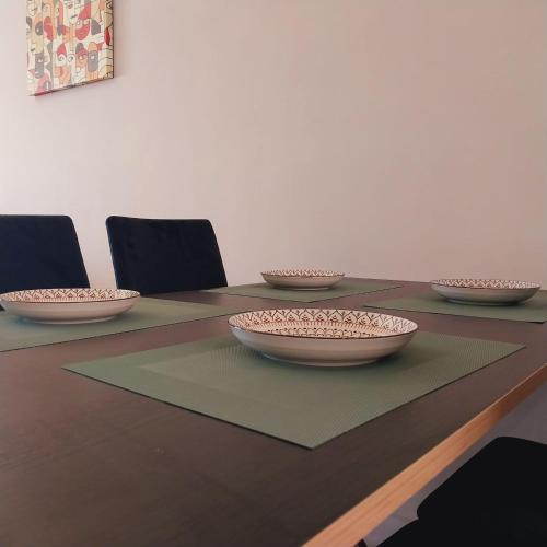 a table with four bowls on top of it at Family airport relax apartment in Deroua