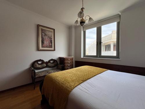 a bedroom with a bed and a window at Povoa Center Beach Apartment in Póvoa de Varzim