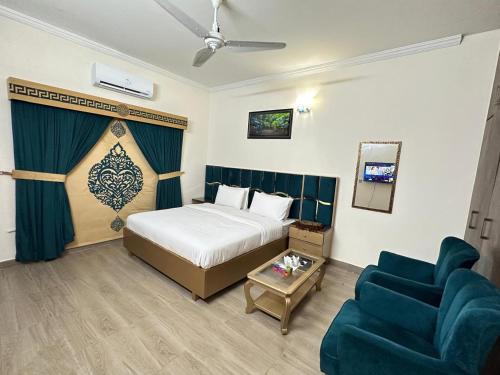 a hotel room with a bed and a couch at Travis Executive Guest House Islamabad in Islamabad