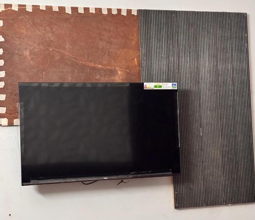 a flat screen tv sitting on top of a wall at Radha Madhavam Luxurious Boutique Stay in Mathura