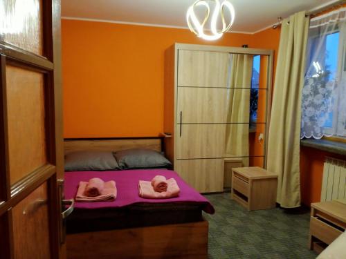 a bedroom with a bed with towels on it at Urocza 20 KRAKÓW in Krakow