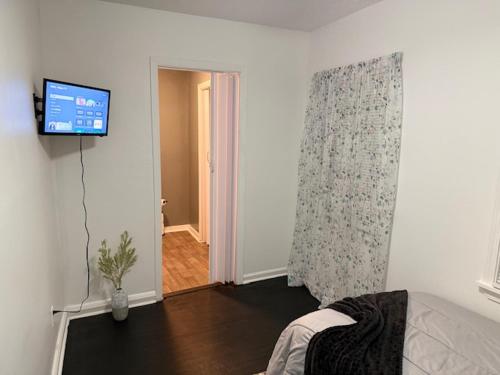 a living room with a tv on a wall at Tiger Suites in Jackson